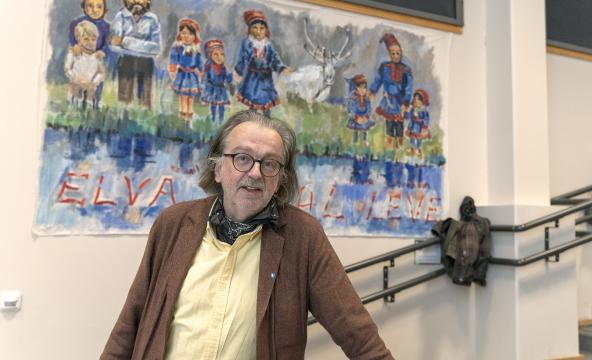 Mann foran bilde av samisk motiv