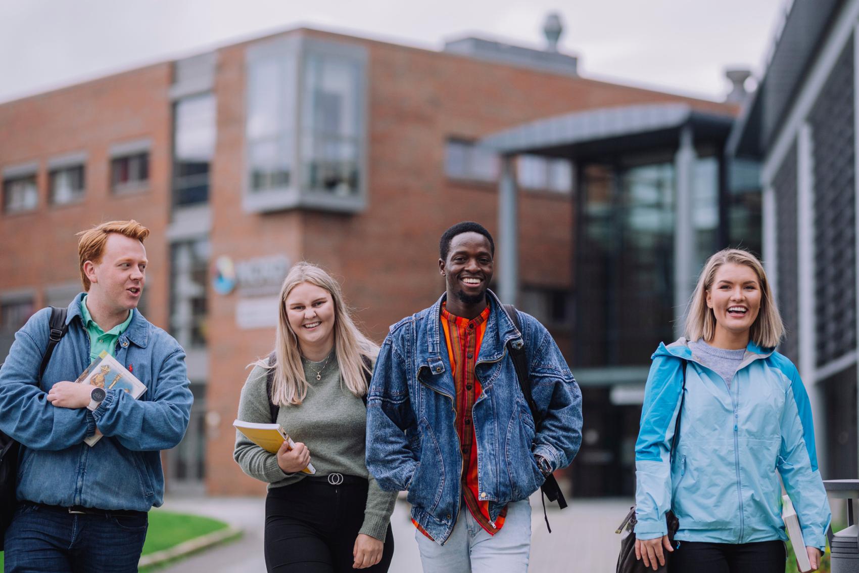 Four students walking outside Bodø campus