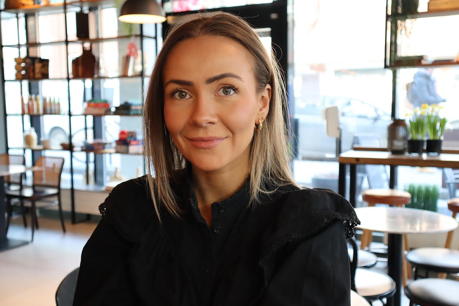 Portrett av ung kvinne inne i en hotell-lobby. Foto