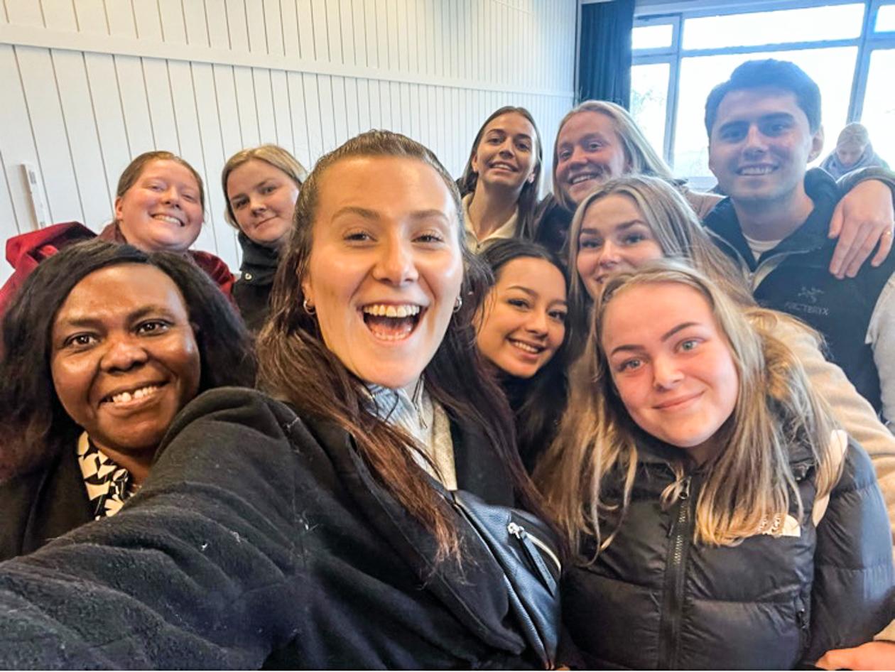 Ti glade gutar og jenter samla tett. Foto.